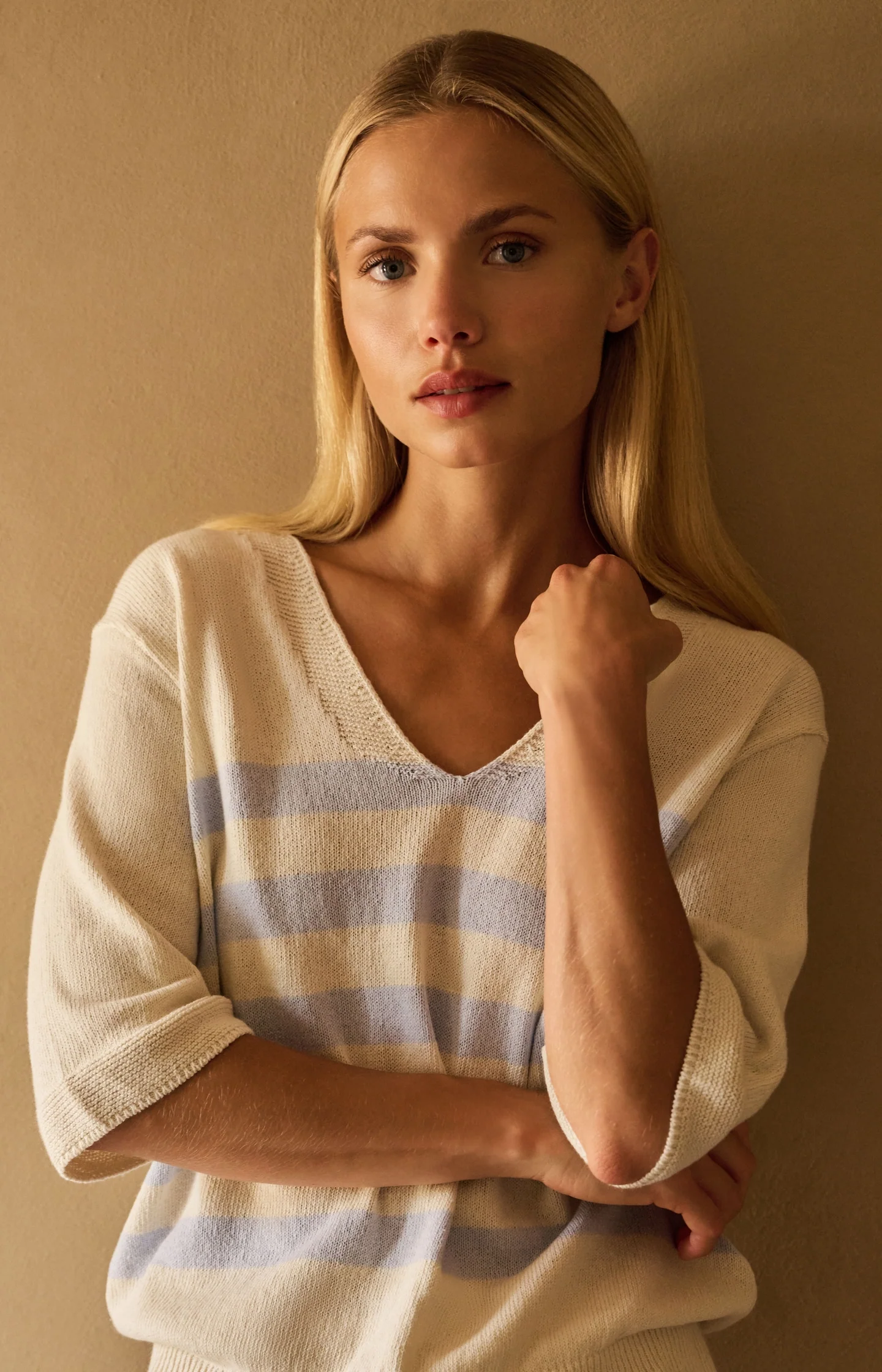 Knitted V-neck sweater with light blue stripes